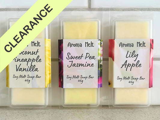 Three Aroma Melt soy melt soap bars with labels on a white background