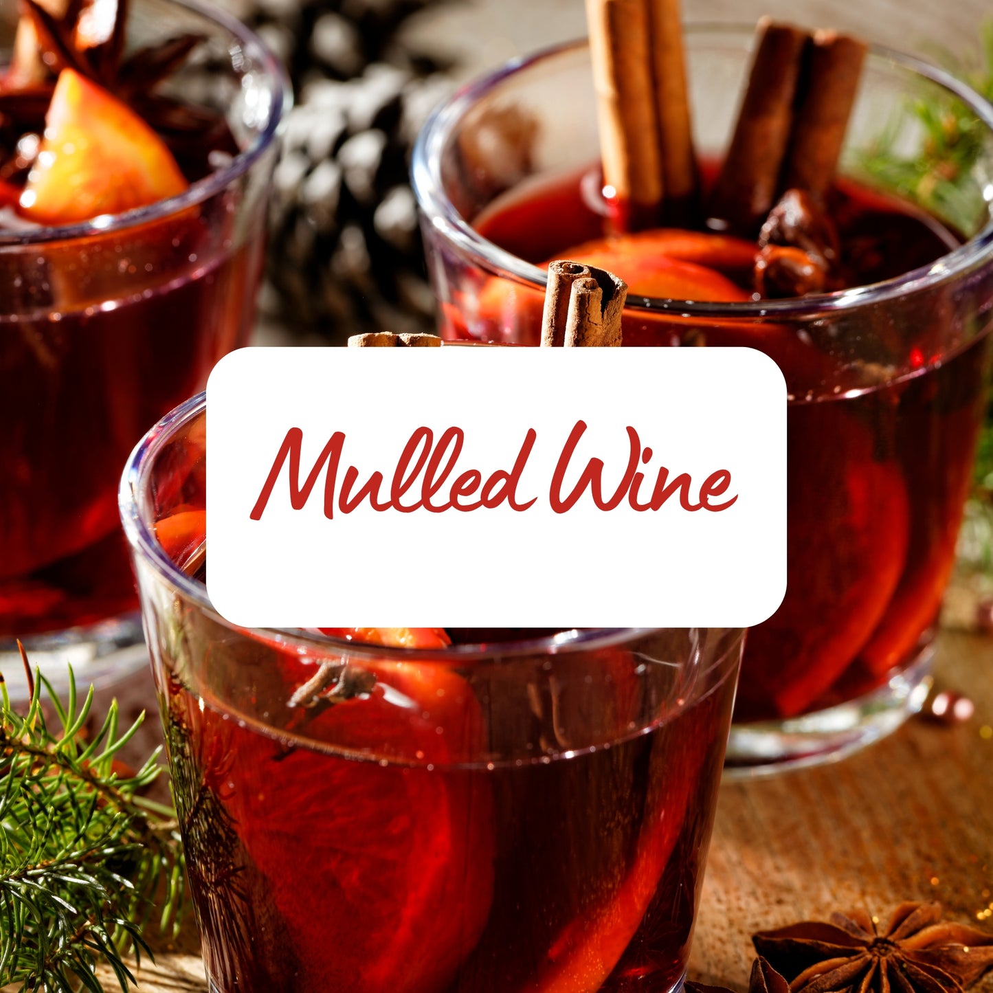 Two glasses of mulled wine with cinnamon sticks and a label reading 'Mulled Wine'.