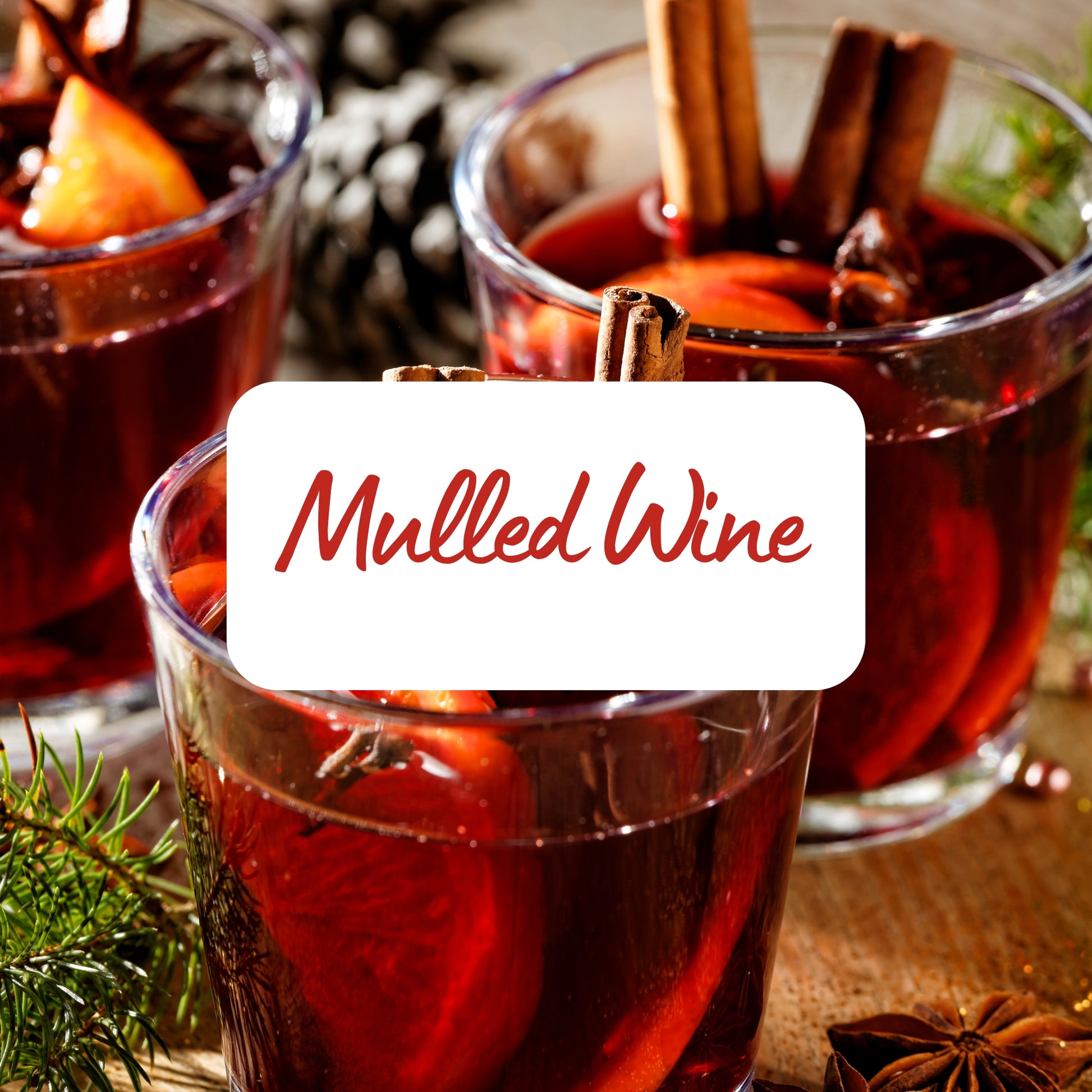 Two glasses of mulled wine with cinnamon sticks and a label reading 'Mulled Wine'.