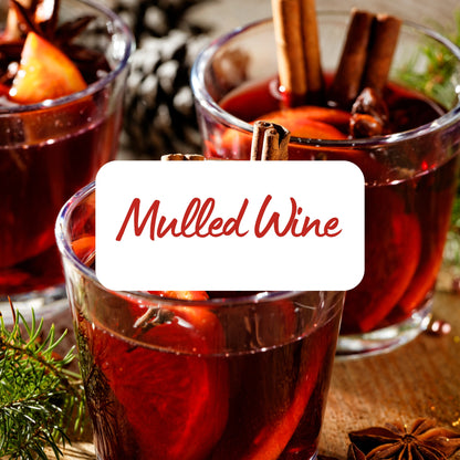 Two glasses of mulled wine with cinnamon sticks and a label reading 'Mulled Wine'.