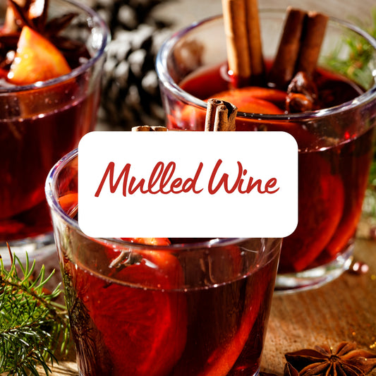 Two glasses of mulled wine with cinnamon sticks and a label reading 'Mulled Wine'.